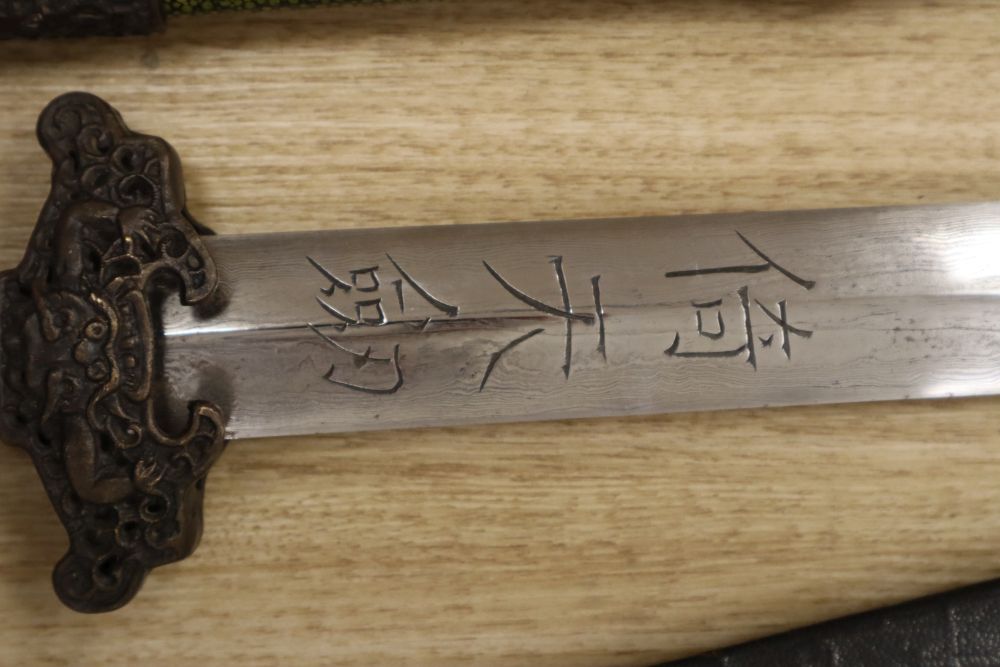 A Chinese sword, 30 inch straight double-edged blade with engraved script, shagreen grip, in shagreen scabbard, and one other sword,